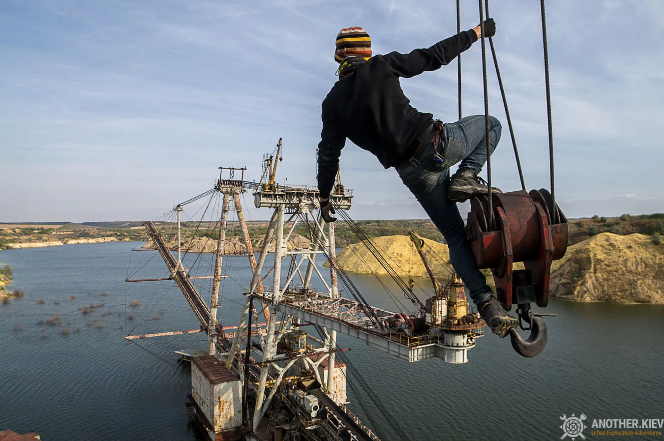 Urban explorer climbing on crane