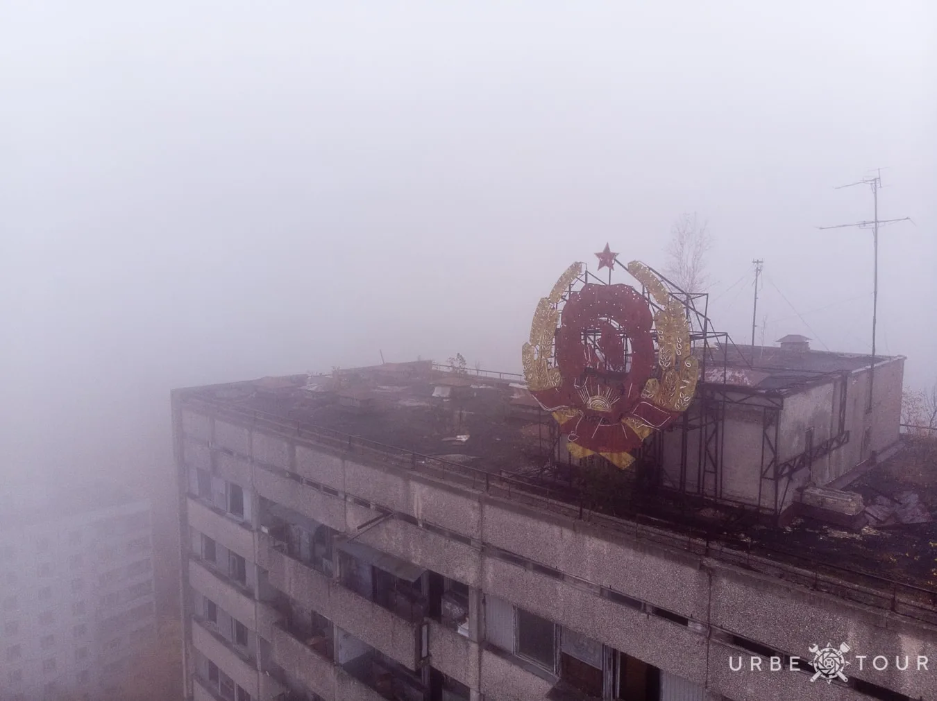 soviet coat of arms on the top of building in Prypiat